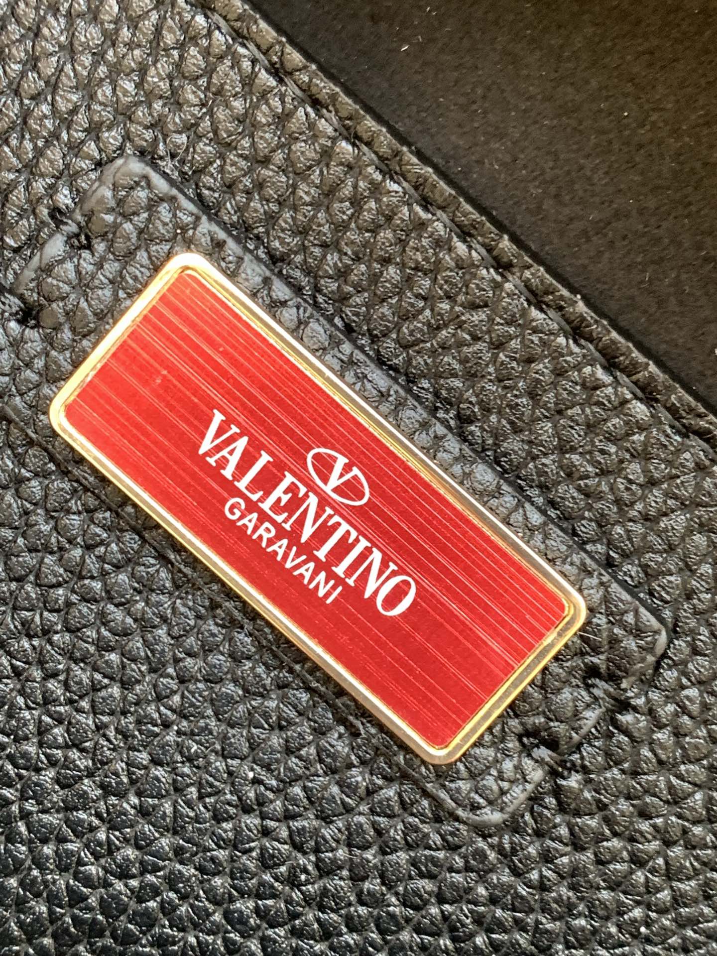 Valen* grain leather envelope bag